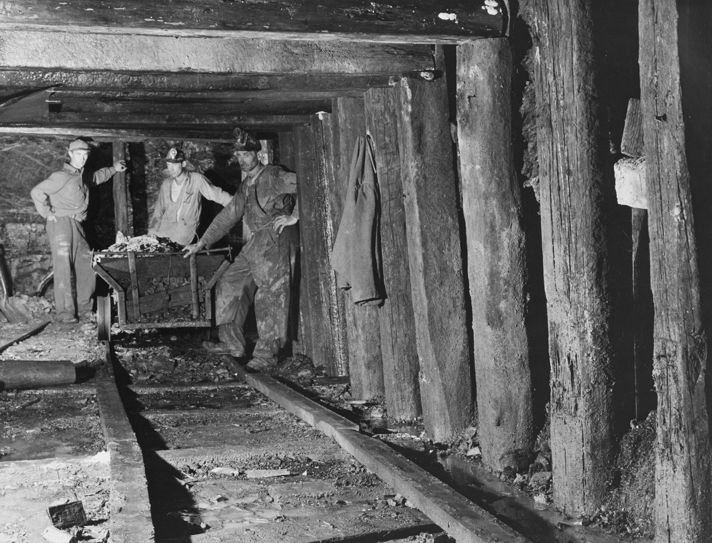 Miners pushing an ore cart