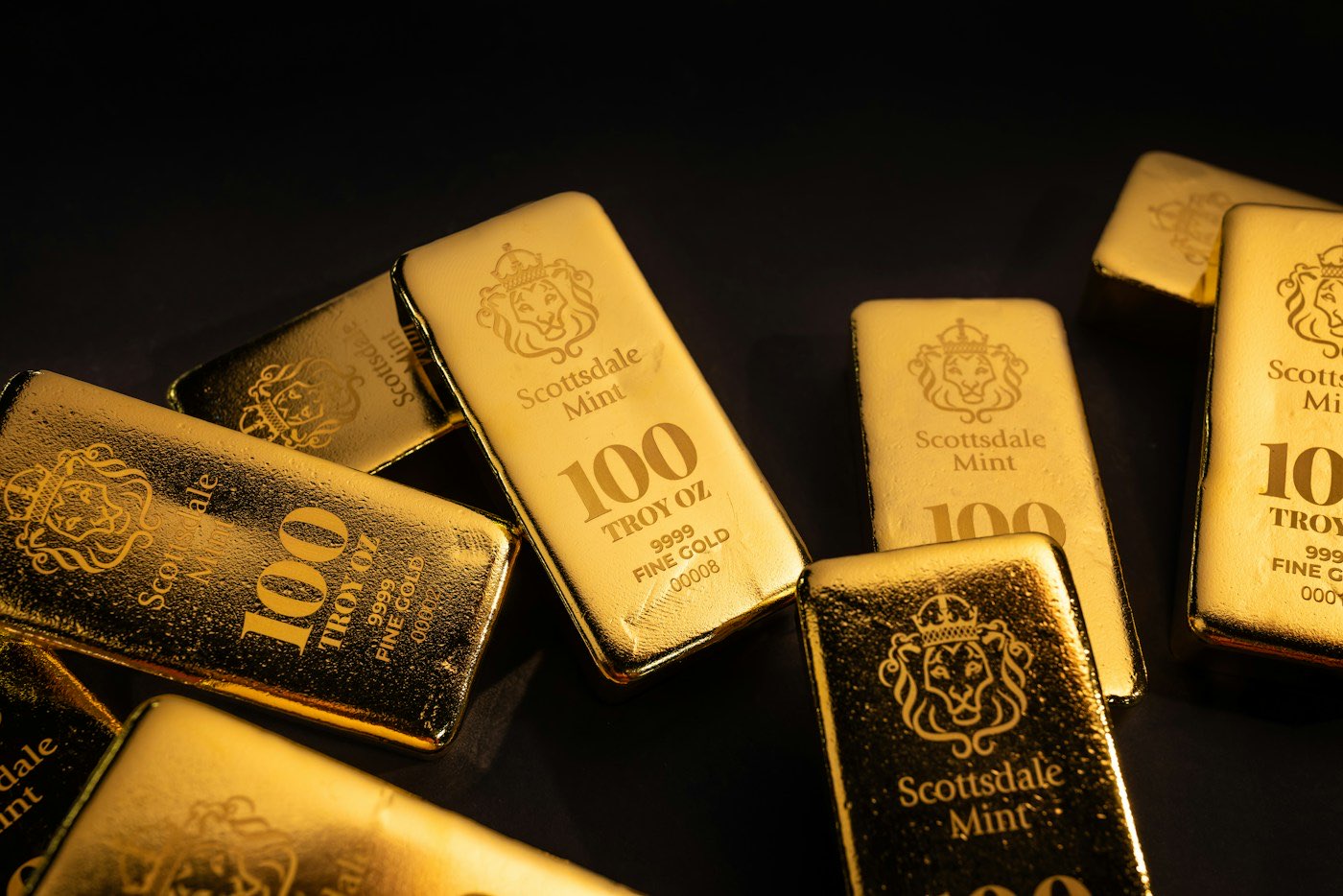 Gold bars on a dark surface