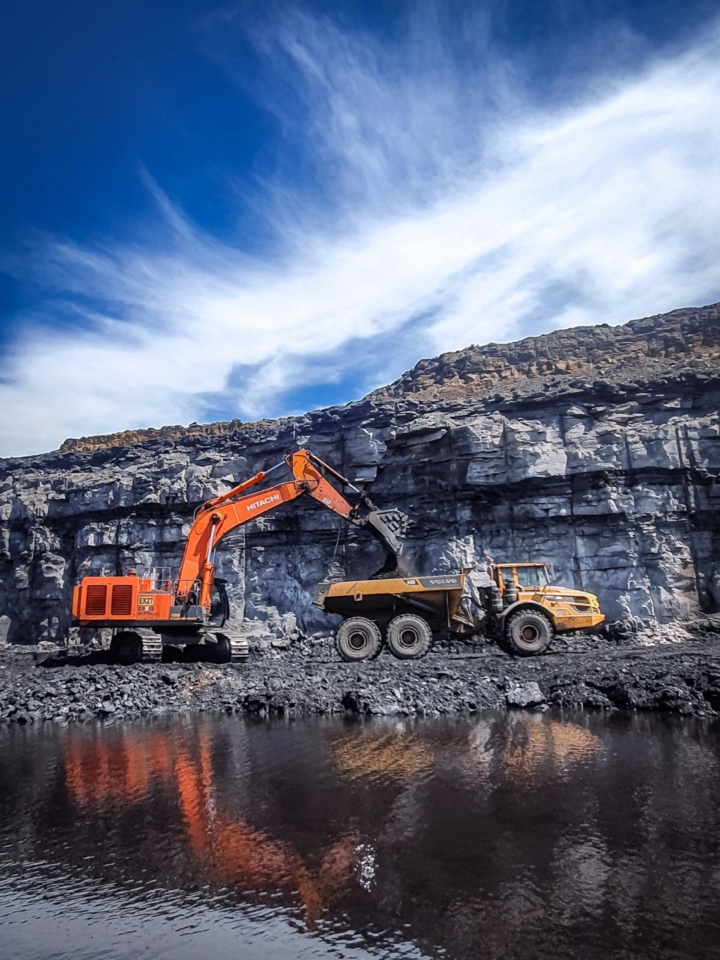 Excavator loading a dump truck